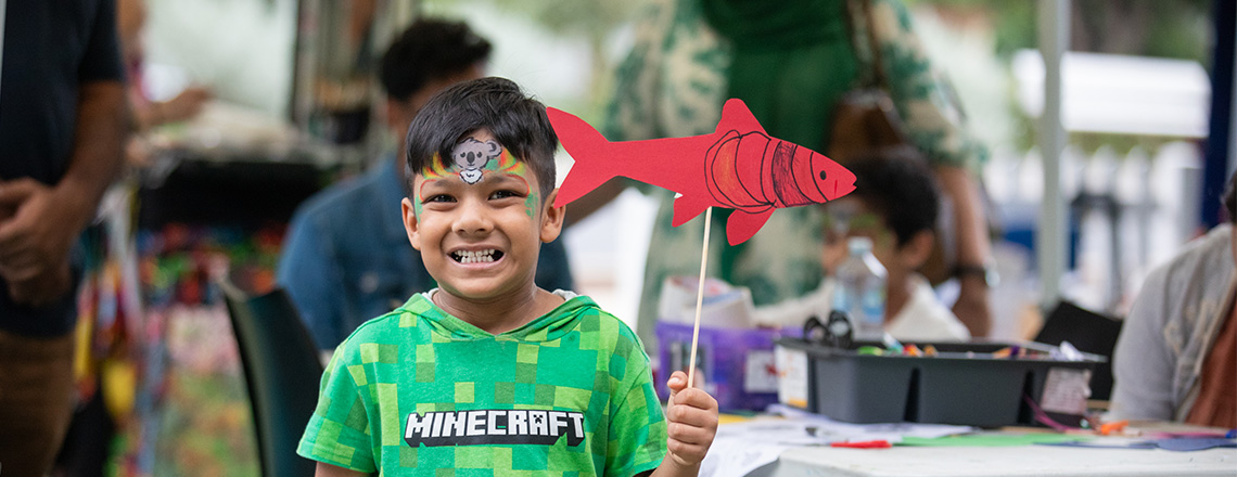 Boy holding a paper fish