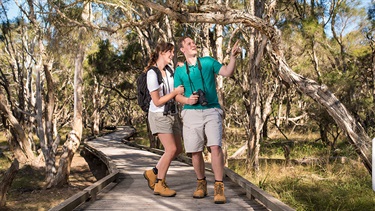 Two people on boardwalk