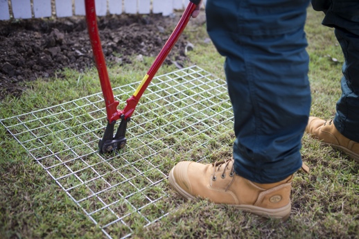 how to stop a dog from going under the fence